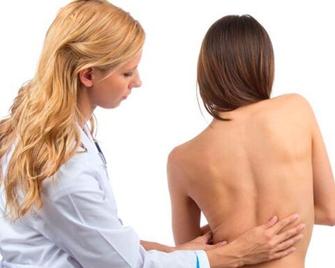 Doctor looks back for lower back pain